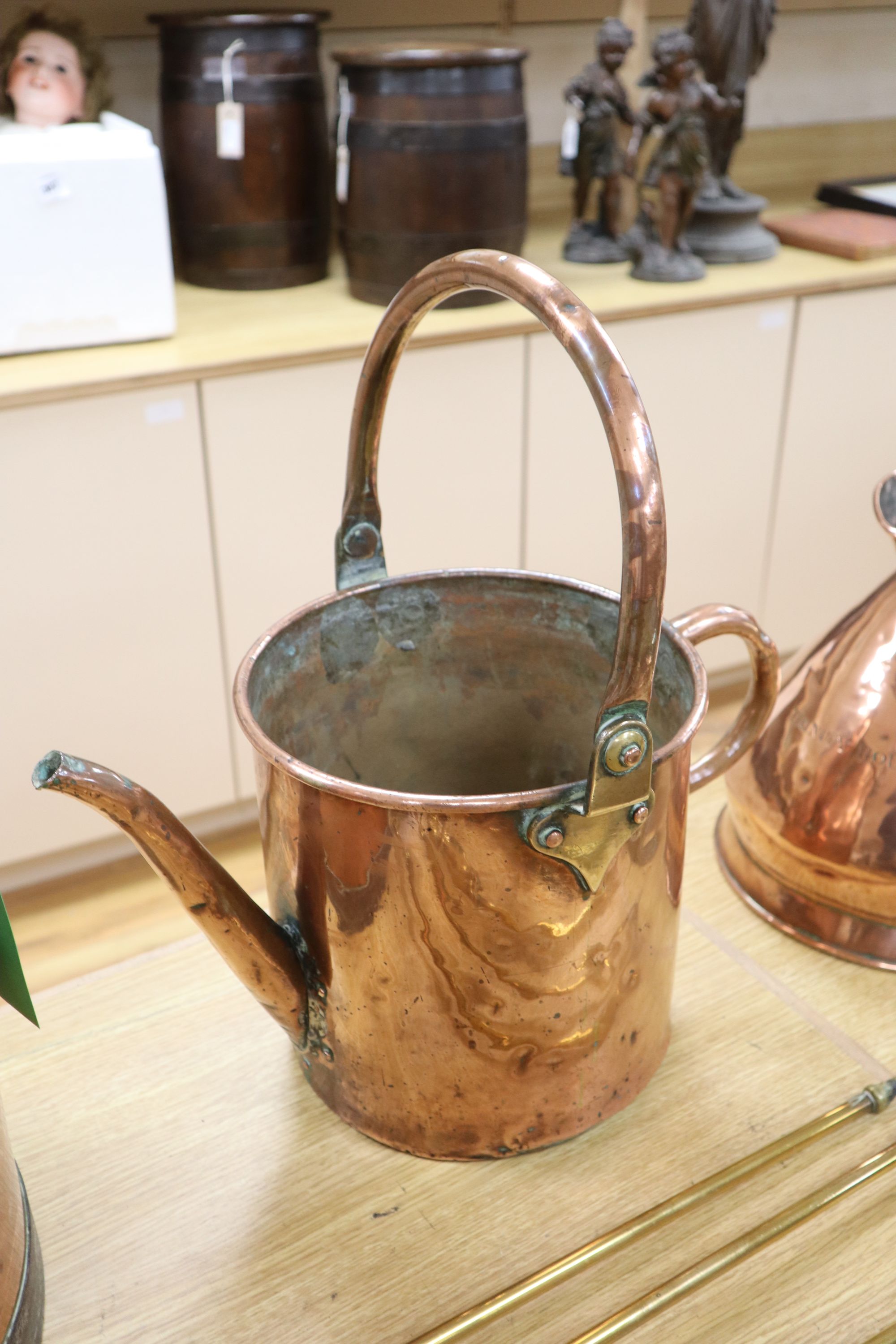 A late Victorian Art Nouveau brass fire kerb, length 132cm, a set of three Victorian fire brasses, a Dutch copper water can and a coppe